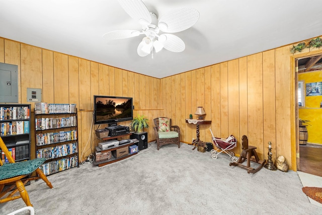 4511 N Stevenson Rd, Otis Orchards, WA 99027 - living area with electric panel, carpet flooring, wooden walls, and ceiling fan