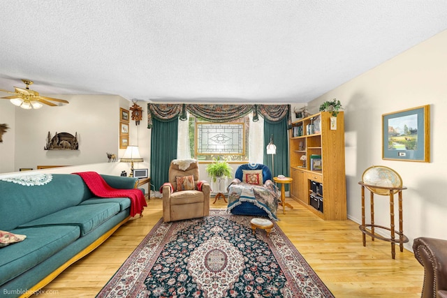 4511 N Stevenson Rd, Otis Orchards, WA 99027 - living room featuring wood finished floors, ceiling fan, and a textured ceiling