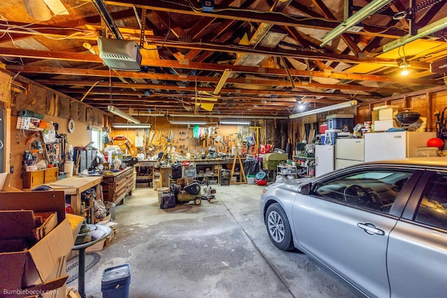 4511 N Stevenson Rd, Otis Orchards, WA 99027 - garage featuring a workshop area, a garage door opener, and freestanding refrigerator