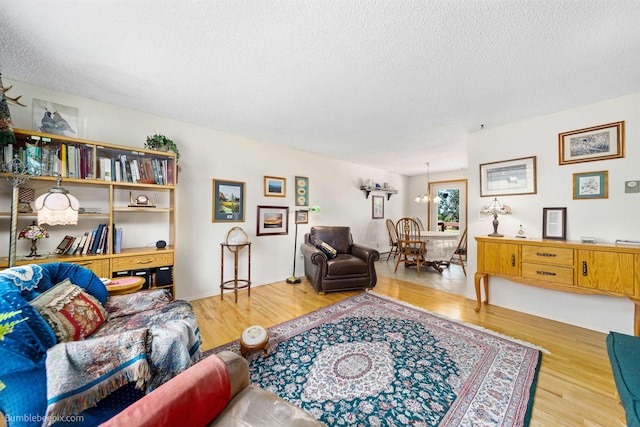 4511 N Stevenson Rd, Otis Orchards, WA 99027 - living area with a textured ceiling, wood finished floors, and a chandelier
