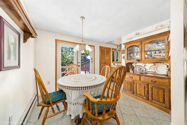 4511 N Stevenson Rd, Otis Orchards, WA 99027 - dining room featuring a baseboard heating unit, light tile patterned floors, and a textured ceiling
