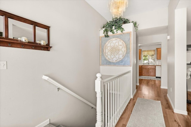 6310 W Sundance Dr, Spokane, WA 99208 - hall featuring an upstairs landing and light wood-type flooring