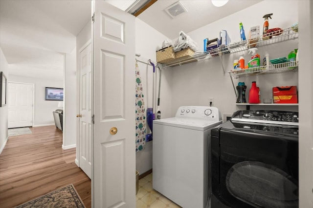 6310 W Sundance Dr, Spokane, WA 99208 - laundry area with separate washer and dryer and light wood-type flooring