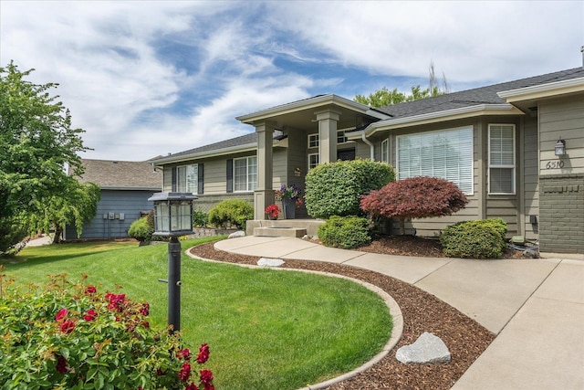 6310 W Sundance Dr, Spokane, WA 99208 - view of front of home with a front yard and brick siding