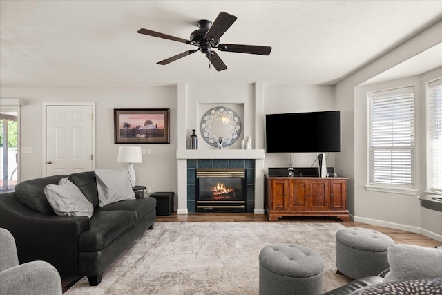 6310 W Sundance Dr, Spokane, WA 99208 - living area featuring wood finished floors, a fireplace, and a ceiling fan