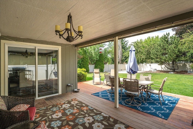 6310 W Sundance Dr, Spokane, WA 99208 - wooden deck with outdoor dining space and a fenced backyard