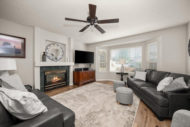 6310 W Sundance Dr, Spokane, WA 99208 - living room with wood finished floors, a ceiling fan, plenty of natural light, and a tile fireplace