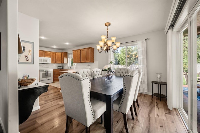 6310 W Sundance Dr, Spokane, WA 99208 - dining space featuring a chandelier, light wood-type flooring, and recessed lighting