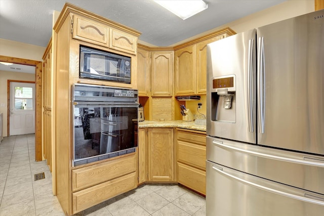 3930 N Deer Lake Rd, Loon Lake, WA 99148 - kitchen with black appliances, light tile patterned flooring, and light brown cabinetry