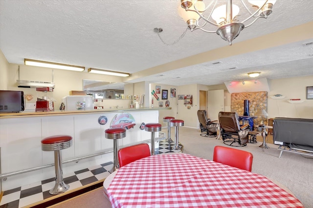 3930 N Deer Lake Rd, Loon Lake, WA 99148 - dining room featuring a wood stove, a textured ceiling, a chandelier, light colored carpet, and light floors