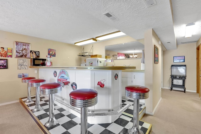 3930 N Deer Lake Rd, Loon Lake, WA 99148 - indoor bar with carpet flooring, tile patterned floors, and a textured ceiling