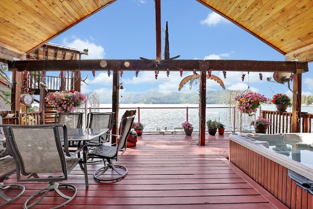 3930 N Deer Lake Rd, Loon Lake, WA 99148 - deck featuring a water view, outdoor dining area, and a hot tub