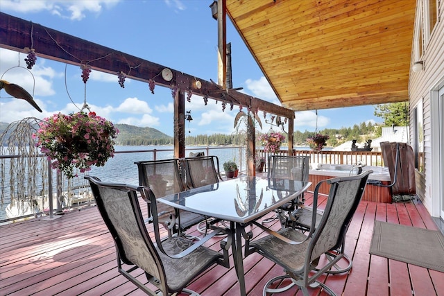 3930 N Deer Lake Rd, Loon Lake, WA 99148 - wooden terrace with a water view and outdoor dining space