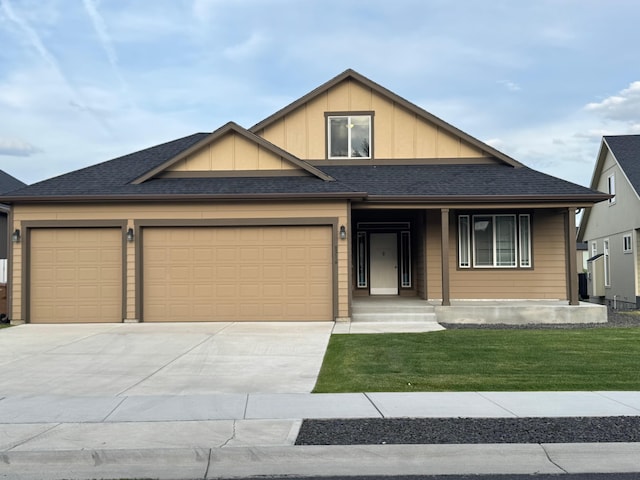 8516 N Summerhill Ln, Spokane, WA 99208 - view of front of property with concrete driveway, an attached garage, board and batten siding, a front yard, and a porch
