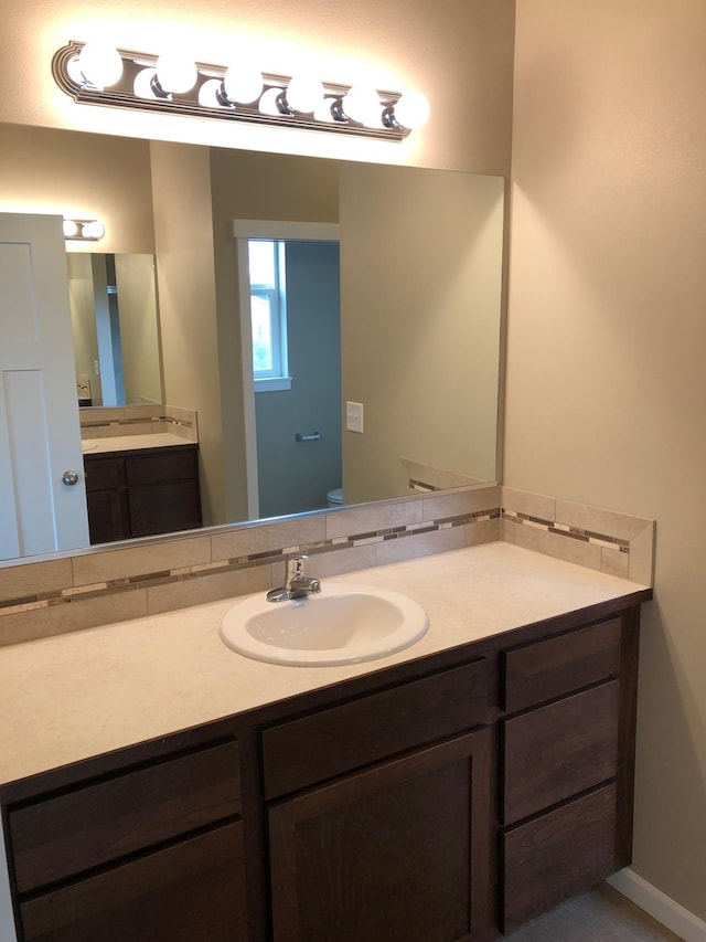 8516 N Summerhill Ln, Spokane, WA 99208 - bathroom with vanity and decorative backsplash