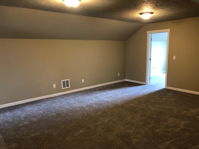 8516 N Summerhill Ln, Spokane, WA 99208 - bonus room with dark colored carpet, lofted ceiling, and a textured ceiling