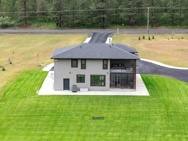 16215 W Coulee Hite Rd, Spokane, WA 99224 - back of house featuring a balcony, a patio area, a lawn, and a shingled roof