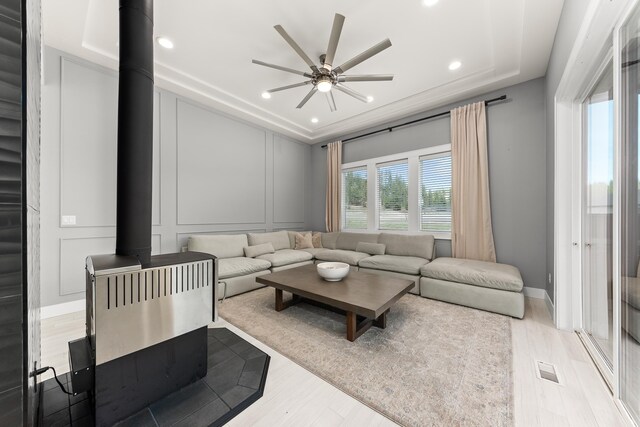 16215 W Coulee Hite Rd, Spokane, WA 99224 - living room featuring wood finished floors, a wood stove, a decorative wall, ceiling fan, and recessed lighting