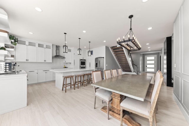 16215 W Coulee Hite Rd, Spokane, WA 99224 - dining area featuring stairs, light wood-style flooring, a chandelier, and recessed lighting