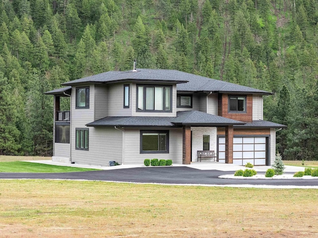 16215 W Coulee Hite Rd, Spokane, WA 99224 - prairie-style house with asphalt driveway, a view of trees, a garage, and a front yard