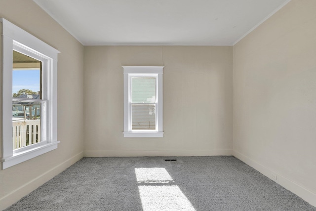 1407 E Broad Ave, Spokane, WA 99207 - carpeted empty room with healthy amount of natural light and crown molding