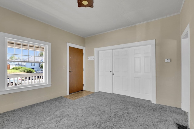 1407 E Broad Ave, Spokane, WA 99207 - unfurnished bedroom featuring carpet, ornamental molding, and a closet