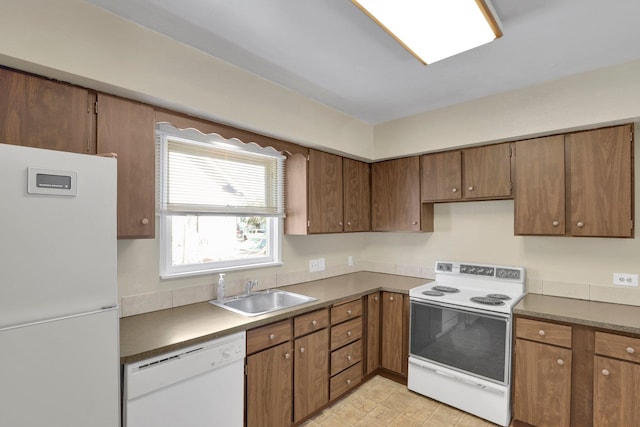 1407 E Broad Ave, Spokane, WA 99207 - kitchen featuring white appliances and brown cabinetry