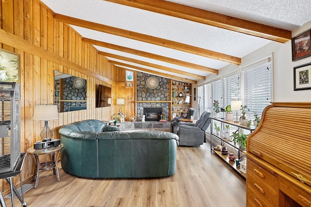 3425 E Upriver Dr, Spokane, WA 99217 - living area featuring light wood-style floors, a stone fireplace, wood walls, and a textured ceiling