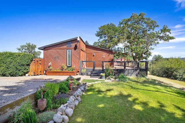 3425 E Upriver Dr, Spokane, WA 99217 - rear view of property with a wooden deck, a lawn, and a gate