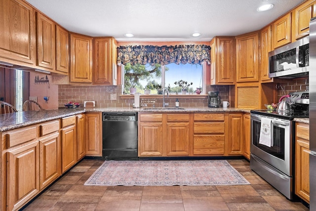 3425 E Upriver Dr, Spokane, WA 99217 - kitchen featuring stainless steel appliances, decorative backsplash, light stone countertops, recessed lighting, and brown cabinets