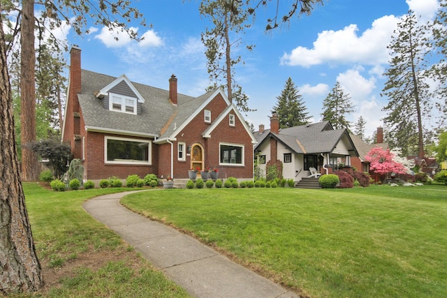 1103 W 20th Ave, Spokane, WA 99203 - view of front facade with brick siding, a front yard, a chimney, and a shingled roof