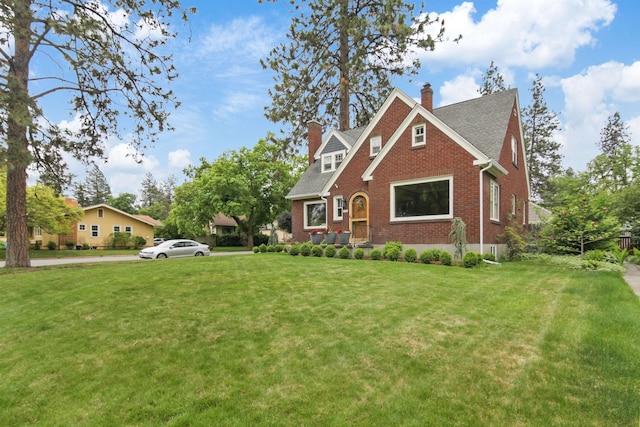1103 W 20th Ave, Spokane, WA 99203 - view of front facade featuring a chimney, brick siding, a front yard, and roof with shingles