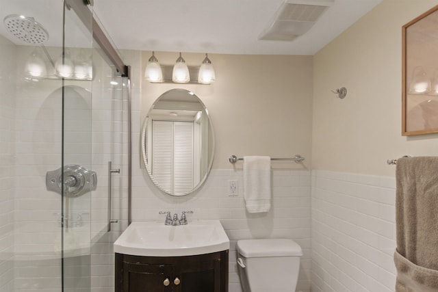 1103 W 20th Ave, Spokane, WA 99203 - bathroom featuring a shower stall, vanity, tile walls, and wainscoting