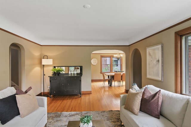 1103 W 20th Ave, Spokane, WA 99203 - living room with arched walkways, a chandelier, wood finished floors, and crown molding