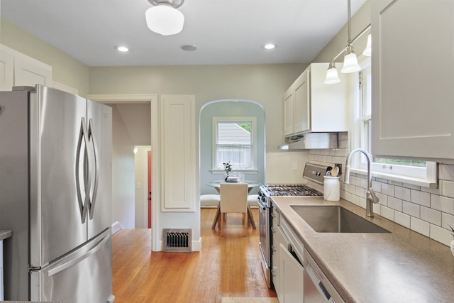 1103 W 20th Ave, Spokane, WA 99203 - kitchen featuring appliances with stainless steel finishes, tasteful backsplash, white cabinets, pendant lighting, and recessed lighting