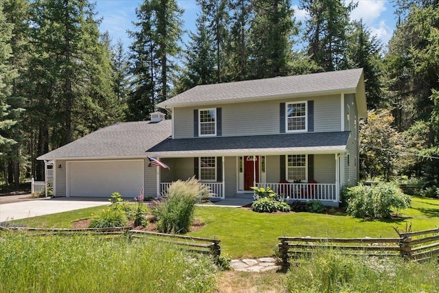 5245A W Prufer Crosscut Rd, Deer Park, WA 99006 - view of front facade featuring a porch, concrete driveway, an attached garage, and a front yard