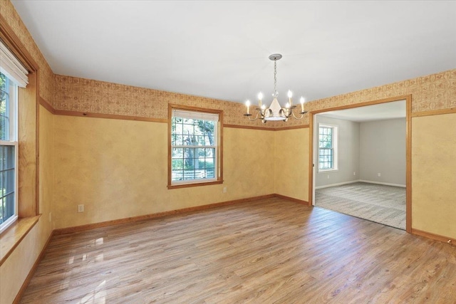 5245A W Prufer Crosscut Rd, Deer Park, WA 99006 - spare room with a chandelier, wood finished floors, and wallpapered walls
