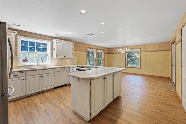 5245A W Prufer Crosscut Rd, Deer Park, WA 99006 - kitchen featuring white dishwasher, freestanding refrigerator, wallpapered walls, a chandelier, and light countertops