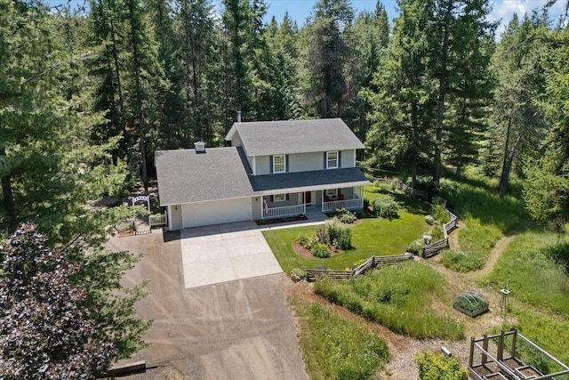 5245A W Prufer Crosscut Rd, Deer Park, WA 99006 - view of front facade featuring covered porch, concrete driveway, a forest view, and a garage