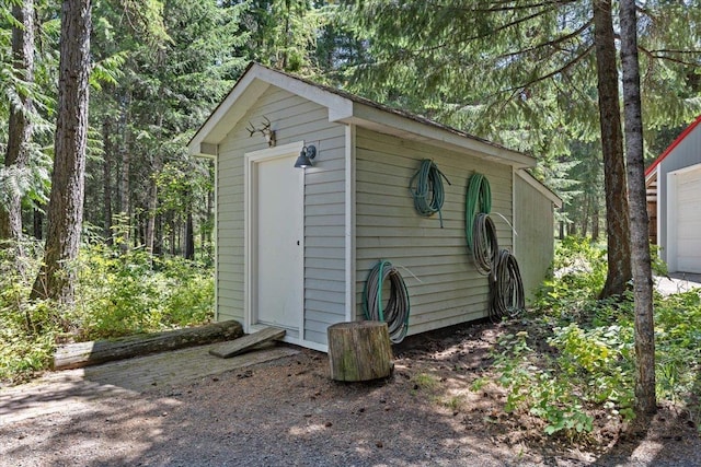 5245A W Prufer Crosscut Rd, Deer Park, WA 99006 - view of shed with a garage and a view of trees