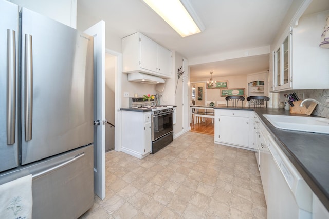 5224 N Post St, Spokane, WA 99204 - kitchen with freestanding refrigerator, range with gas cooktop, white dishwasher, and dark countertops