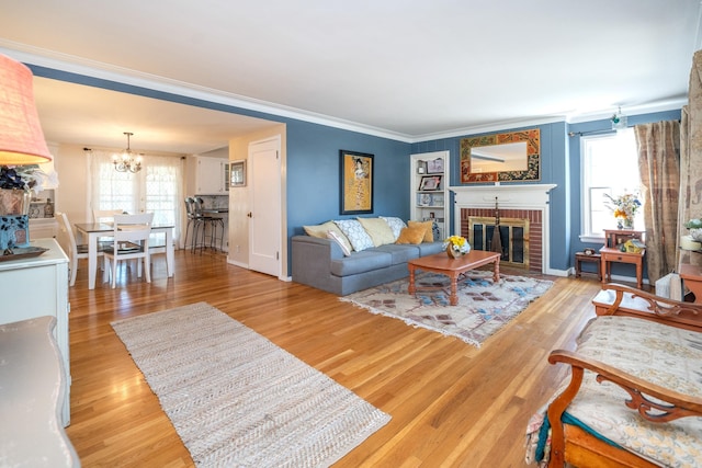 5224 N Post St, Spokane, WA 99204 - living room with a chandelier, healthy amount of natural light, a brick fireplace, light wood-style flooring, and ornamental molding