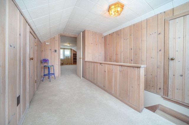 5224 N Post St, Spokane, WA 99204 - corridor with light colored carpet, wood walls, and vaulted ceiling