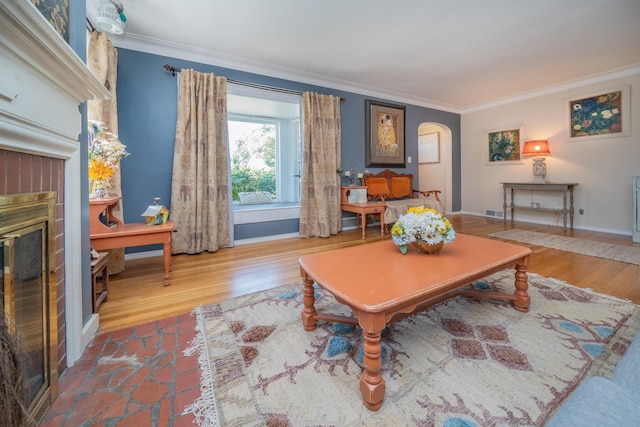 5224 N Post St, Spokane, WA 99204 - living area with a fireplace, arched walkways, ornamental molding, and wood finished floors