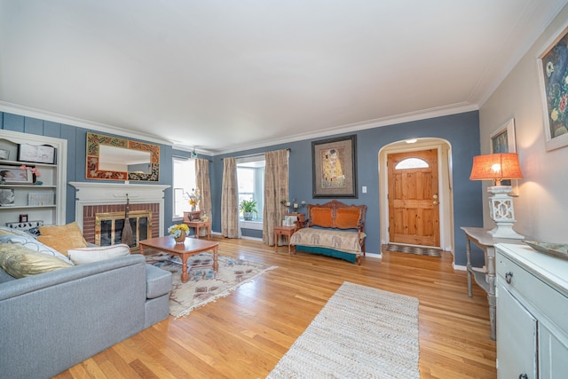 5224 N Post St, Spokane, WA 99204 - living area with crown molding, arched walkways, a fireplace, and light wood finished floors