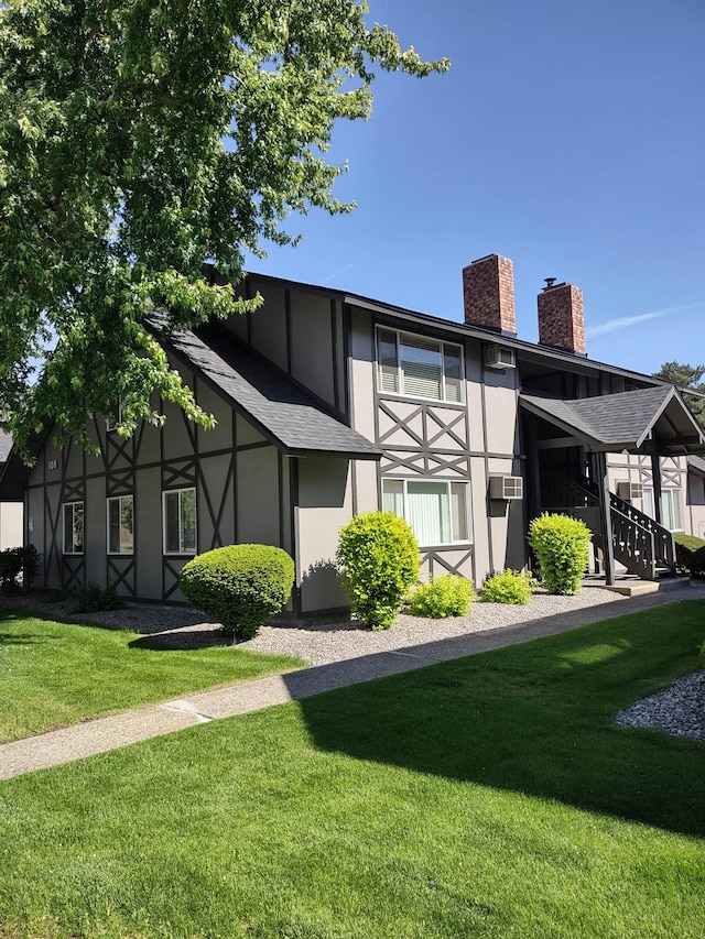108 E Weile Ave # 1, Spokane, WA 99208 - back of house with a chimney, a yard, a shingled roof, and stucco siding