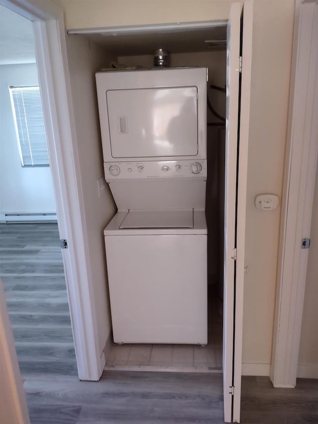 108 E Weile Ave # 1, Spokane, WA 99208 - washroom with stacked washing machine and dryer, a baseboard radiator, and wood finished floors