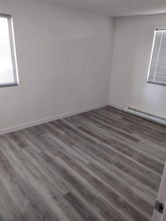 108 E Weile Ave # 1, Spokane, WA 99208 - unfurnished room with a baseboard heating unit and wood finished floors