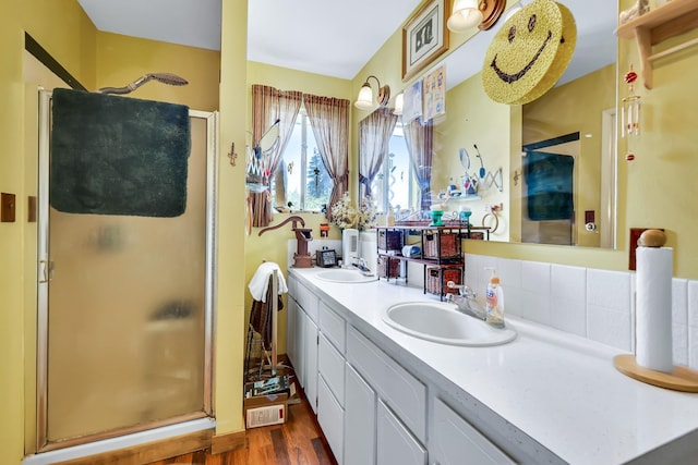 1401 W 1st St, Newport, WA 99156 - bathroom featuring a shower stall, double vanity, and wood finished floors