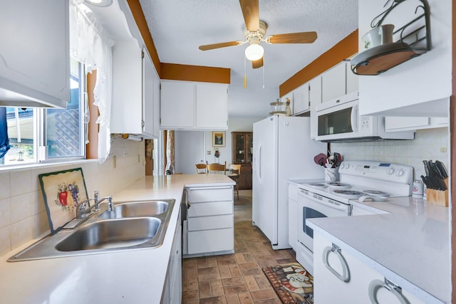 1401 W 1st St, Newport, WA 99156 - kitchen with white appliances, ceiling fan, tasteful backsplash, and light countertops